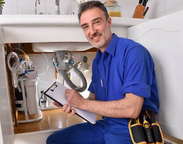 Pink Flamingo Plumbing technician completing a kitchen plumbing job
